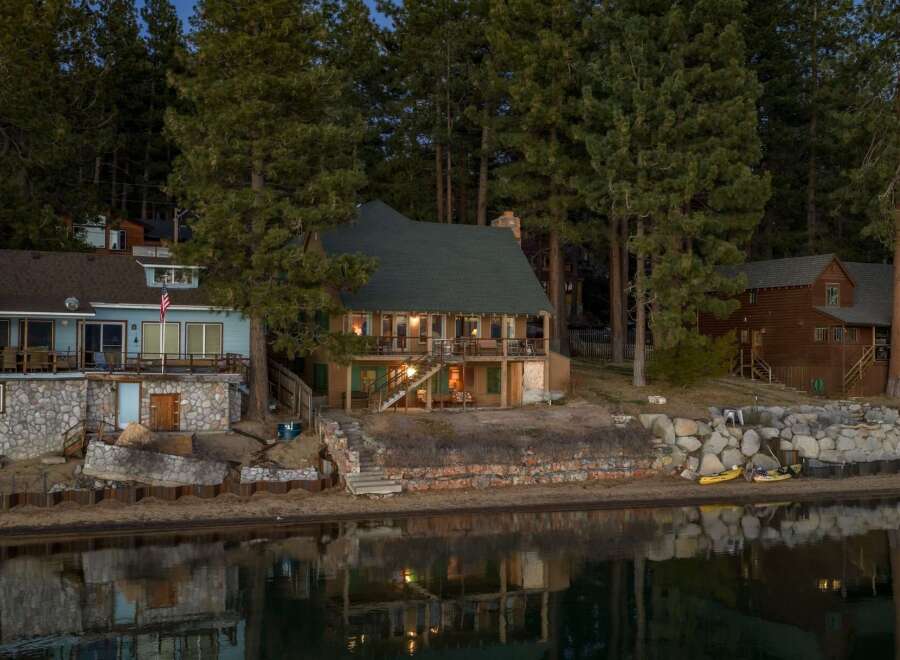 This stunning waterfront property offers a serene escape with its charming architecture and picturesque setting.