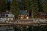 This stunning waterfront property offers a serene escape with its charming architecture and picturesque setting.