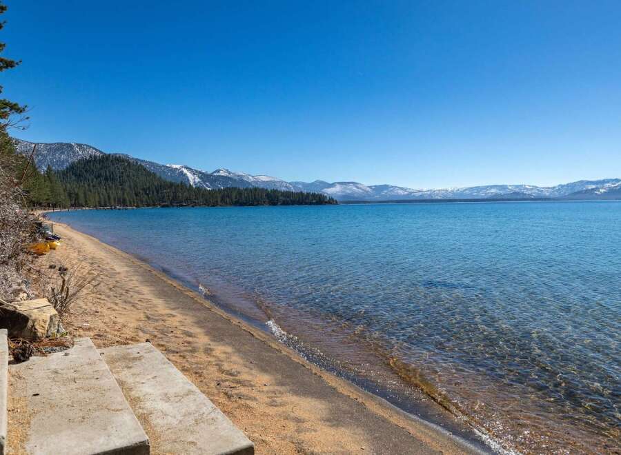 Enjoy breathtaking views of the lake and mountains from this stunning property.