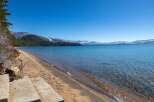 Enjoy breathtaking views of the lake and mountains from this stunning property.