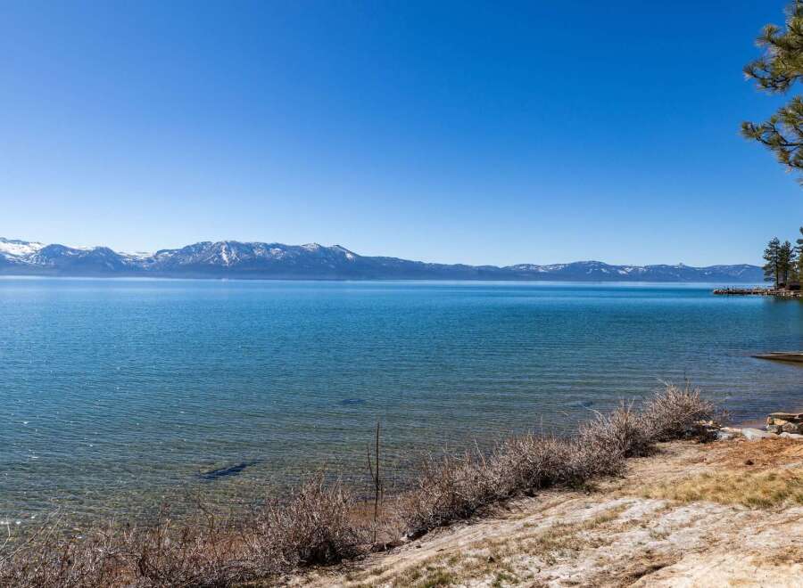 Enjoy breathtaking views of the lake and snow-capped mountains from this stunning property.