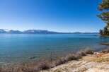 Enjoy breathtaking views of the lake and snow-capped mountains from this stunning property.