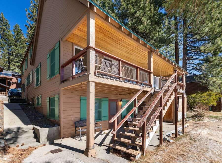 This charming two-story home boasts a welcoming exterior with a wooden facade and inviting porch.