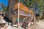 This charming two-story home boasts a welcoming exterior with a wooden facade and inviting porch.