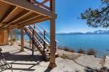 Enjoy stunning lake views from this charming property! This home features a beautiful wooden staircase leading to a deck, perfect for relaxing and taking in the scenery.