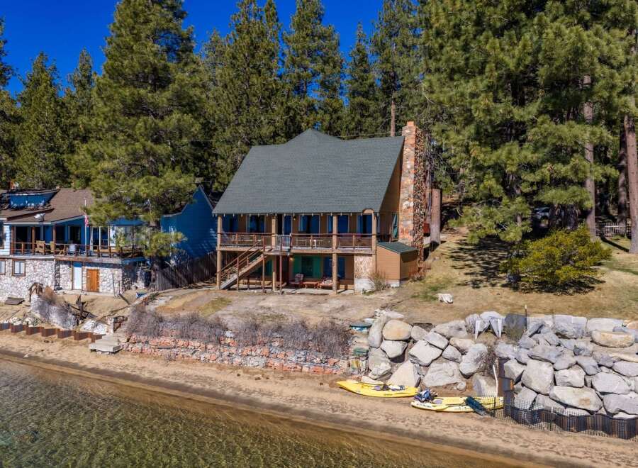 Discover your dream lakeside retreat! This stunning property boasts a charming two-story house with a cozy fireplace and a spacious deck, perfect for enjoying breathtaking views.