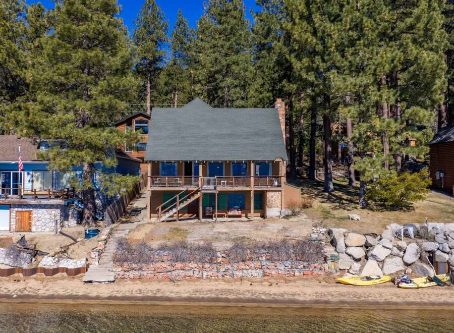 Discover your dream lakeside retreat! This stunning property boasts a charming two-story house with a spacious deck, perfect for enjoying breathtaking views.