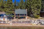 Discover your dream lakeside retreat! This stunning property boasts a charming two-story house with a spacious deck, perfect for enjoying breathtaking views.