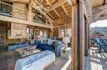 Experience rustic luxury in this stunning chalet, featuring exposed wooden beams and a cozy fireplace.