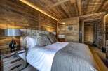 Experience rustic luxury in this stunning bedroom.