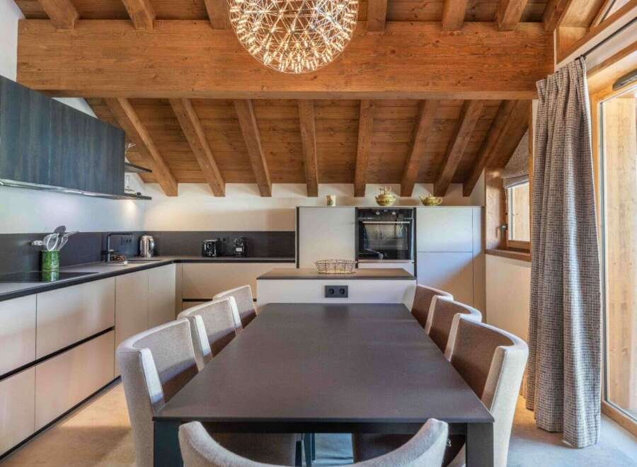 This stunning kitchen and dining area boasts a warm and inviting atmosphere, perfect for entertaining or enjoying family meals.