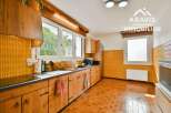 Step into this charming kitchen, featuring warm wooden cabinetry and a classic design.