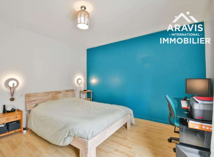 Discover this inviting bedroom featuring a comfortable bed and a stylish blue accent wall.