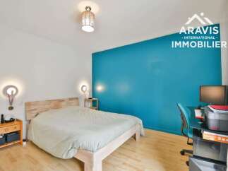 Discover this inviting bedroom featuring a comfortable bed and a stylish blue accent wall.
