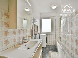 Discover this charming bathroom featuring a modern sink and a convenient washing machine.
