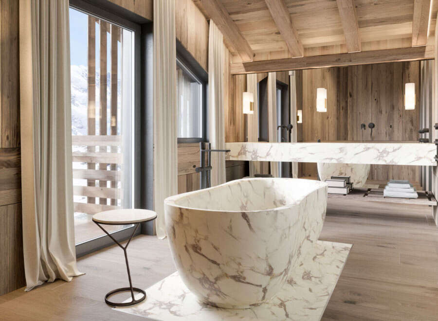 Experience luxury in this stunning bathroom featuring a marble bathtub and sink.
