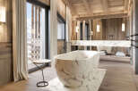 Experience luxury in this stunning bathroom featuring a marble bathtub and sink.