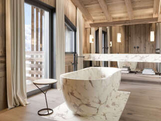 Experience luxury in this stunning bathroom featuring a marble bathtub and sink.