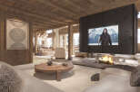 Experience luxury living in this stunning chalet-style home, featuring a cozy living room with a fireplace and a large-screen TV.