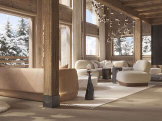 Experience luxurious mountain living in this stunning chalet, featuring a spacious open-plan living area with a modern fireplace and breathtaking snow-covered forest views.