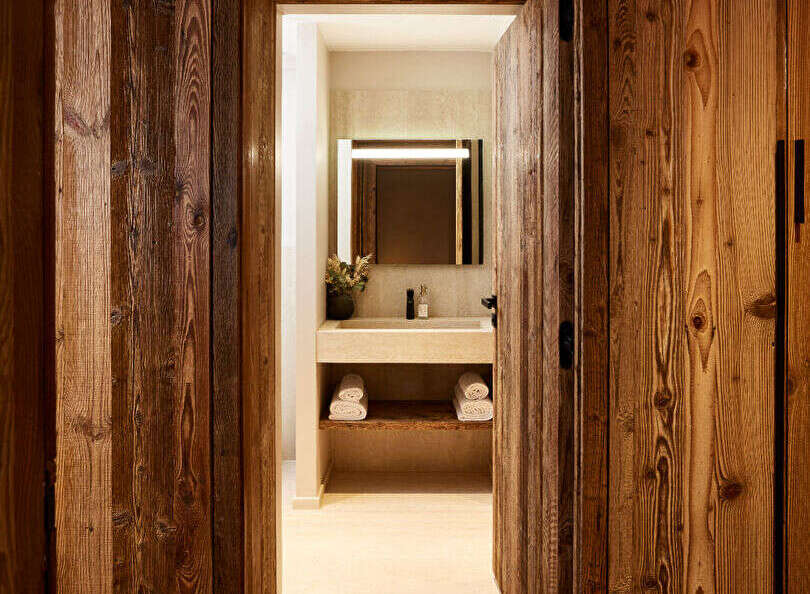 Step into luxury with this stunning property featuring exquisite wood paneling and a beautifully designed bathroom.