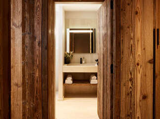 Step into luxury with this stunning property featuring exquisite wood paneling and a beautifully designed bathroom.