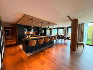 Experience modern mountain living in this stunning open-concept kitchen and dining area.