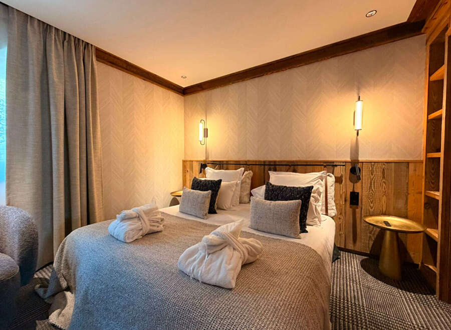Experience ultimate comfort in this beautifully appointed bedroom, featuring a plush king-size bed adorned with soft linens and decorative pillows.
