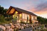This stunning modern home boasts a striking architectural design with expansive windows that capture breathtaking views.