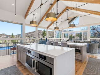 Experience luxury living in this stunning kitchen with breathtaking mountain views.