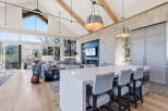 Experience luxury living in this stunning property featuring a modern kitchen with a large island and stylish seating.