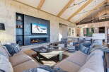 Experience luxury living in this stunning property featuring a cozy fireplace and a modern entertainment setup.
