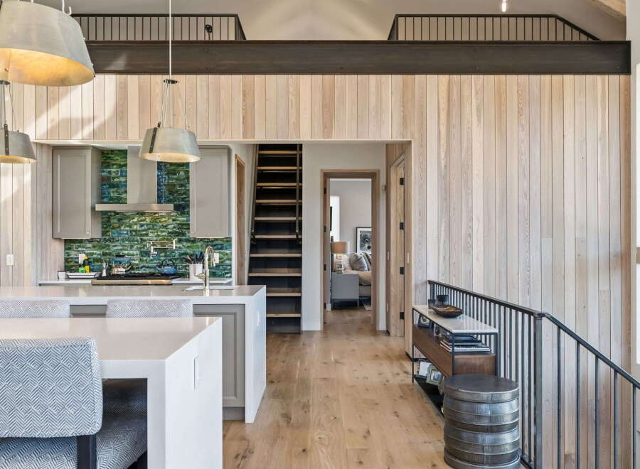 This stunning property boasts a modern kitchen with sleek countertops and stylish pendant lighting, perfect for culinary enthusiasts.