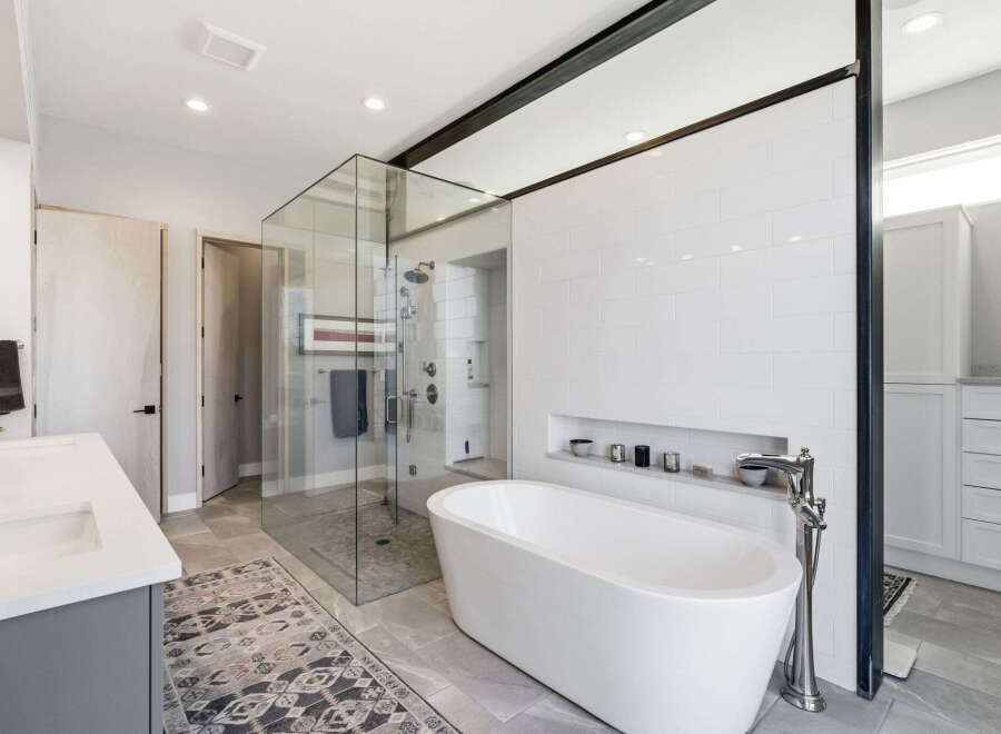 Step into luxury with this stunning bathroom! Featuring a sleek, modern design, this space boasts a beautiful freestanding tub, a glass-enclosed shower, and elegant tile work.