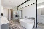 Step into luxury with this stunning bathroom! Featuring a sleek, modern design, this space boasts a beautiful freestanding tub, a glass-enclosed shower, and elegant tile work.