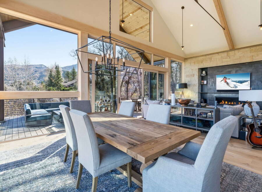 Experience luxury living in this stunning property, featuring a spacious dining area with breathtaking mountain views.