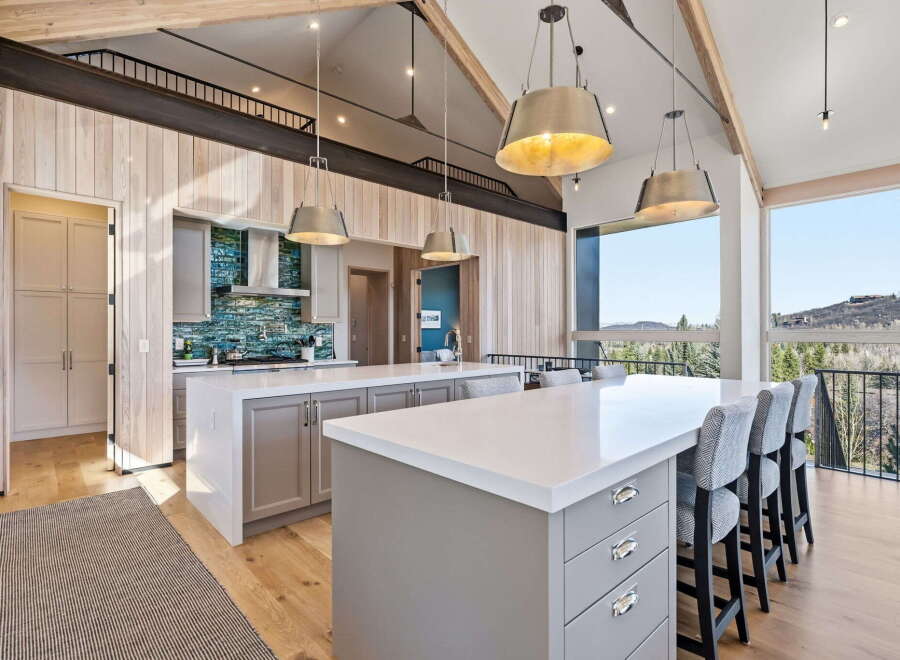 Experience luxury living in this stunning kitchen, featuring a spacious island with seating, perfect for entertaining.