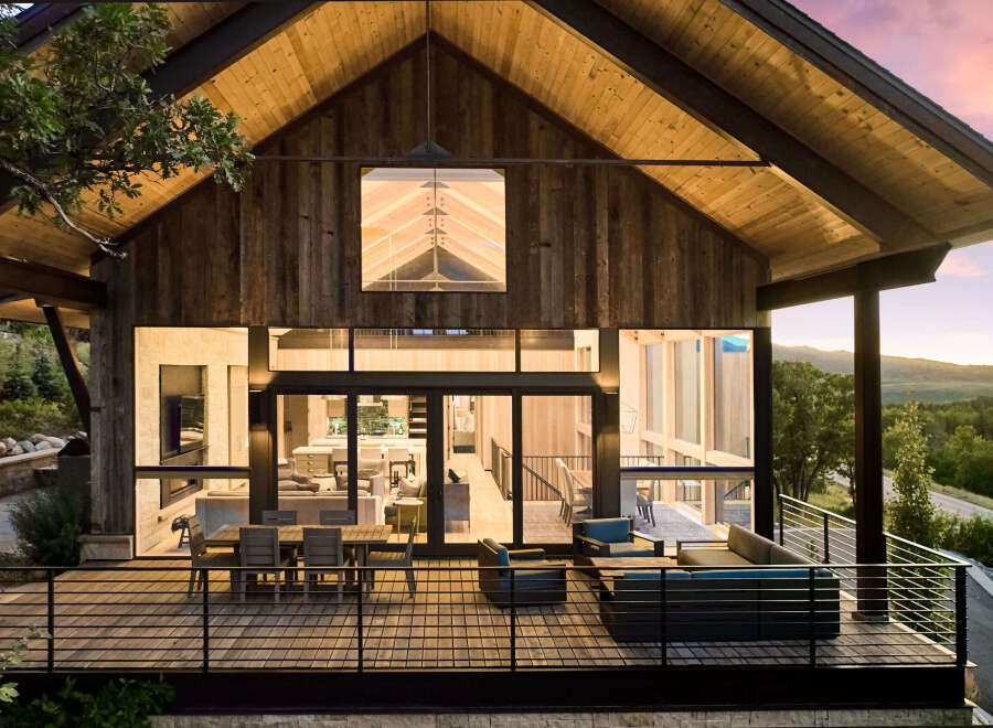 This stunning modern home boasts a striking architectural design with a warm, inviting ambiance.