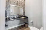 This stunning bathroom boasts a modern design with a floating vanity and a stylish wooden accent wall.