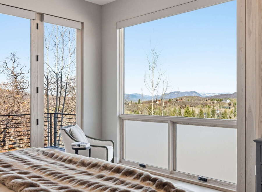 Experience breathtaking views from this luxurious bedroom.