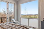 Experience breathtaking views from this luxurious bedroom.