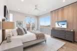 Experience luxury in this stunning bedroom featuring a cozy bed, a stylish dresser, and a modern TV.