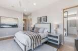 Step into luxury with this stunning bedroom, featuring a plush bed adorned with stylish pillows and a cozy throw.