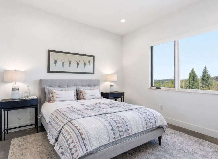 This stunning bedroom offers a serene retreat with its modern design and natural light.