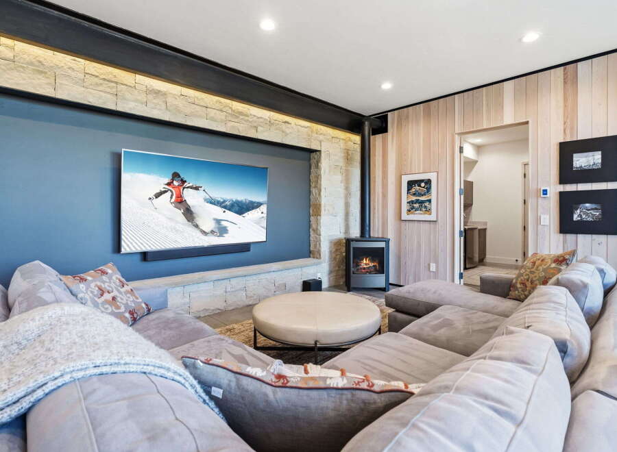 Experience luxury living in this stunning property, featuring a cozy living room with a modern fireplace and a large flat-screen TV perfect for entertainment.