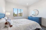 This stunning bedroom boasts a serene ambiance with its bright, airy design and beautiful mountain views.