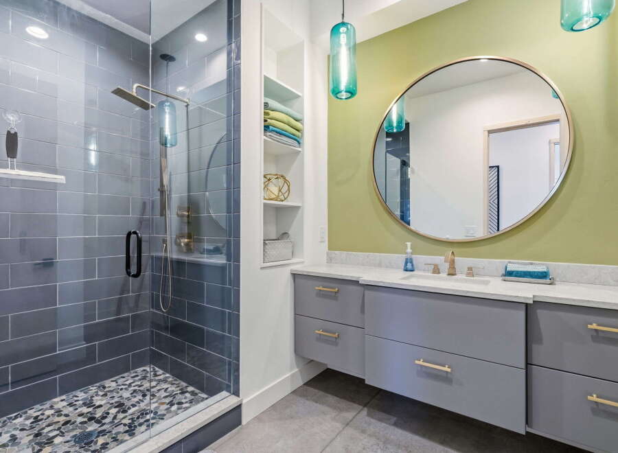 Step into luxury with this stunning bathroom featuring a modern shower and elegant vanity.