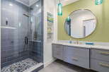 Step into luxury with this stunning bathroom featuring a modern shower and elegant vanity.