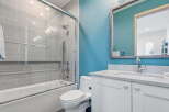 Step into a beautifully designed bathroom featuring a modern shower with glass doors and stylish gray tile.