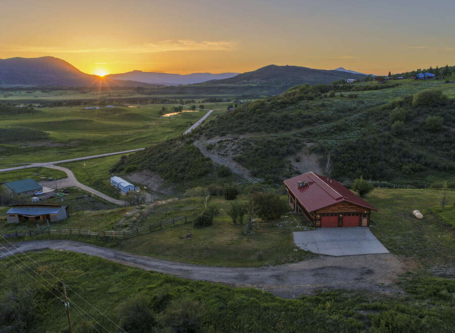 Experience breathtaking sunset views from this stunning property nestled in a serene mountain landscape.